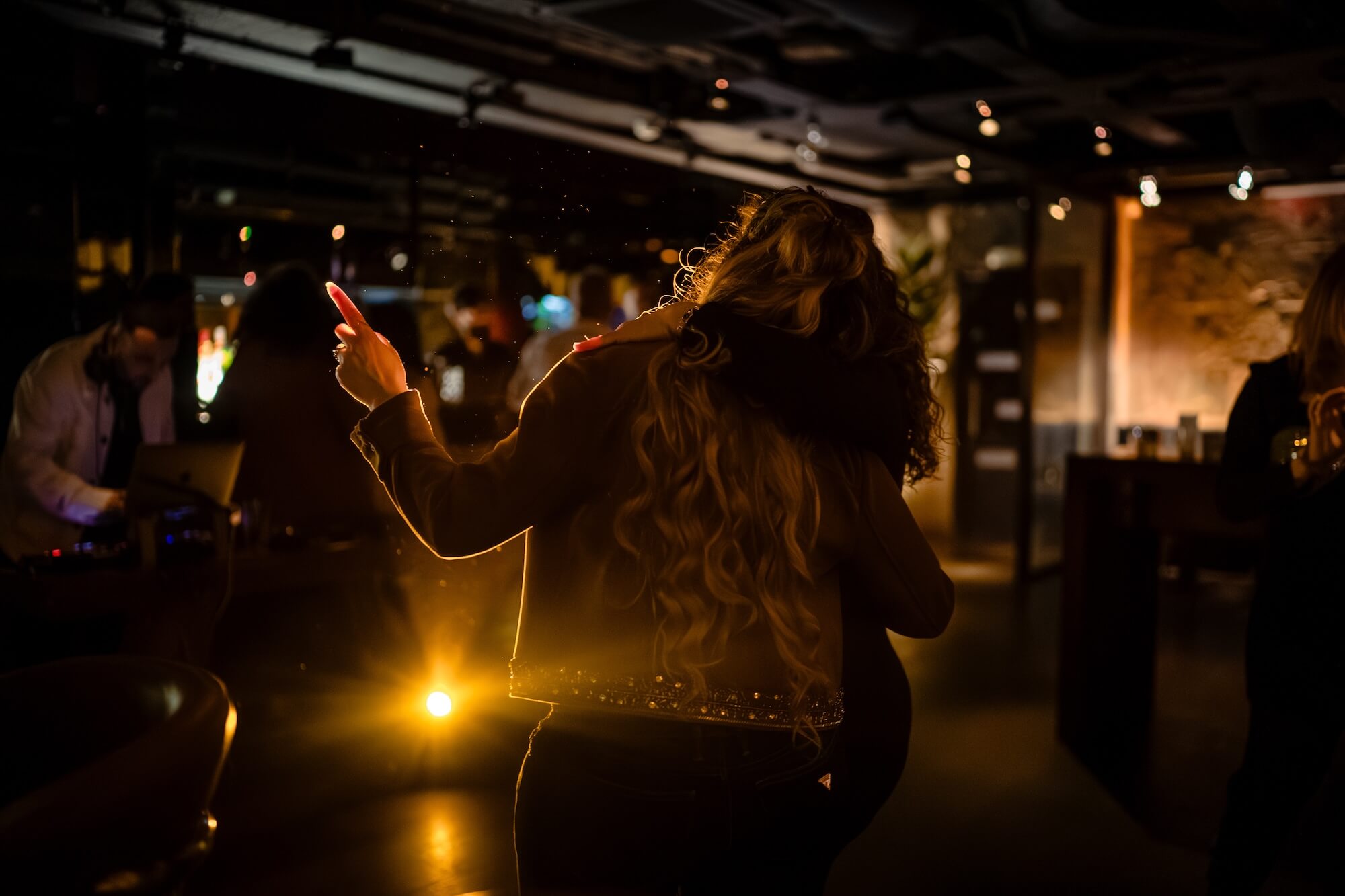 Guests enjoying a wedding after-party in the candlelit space at PÚRL Barbican, London