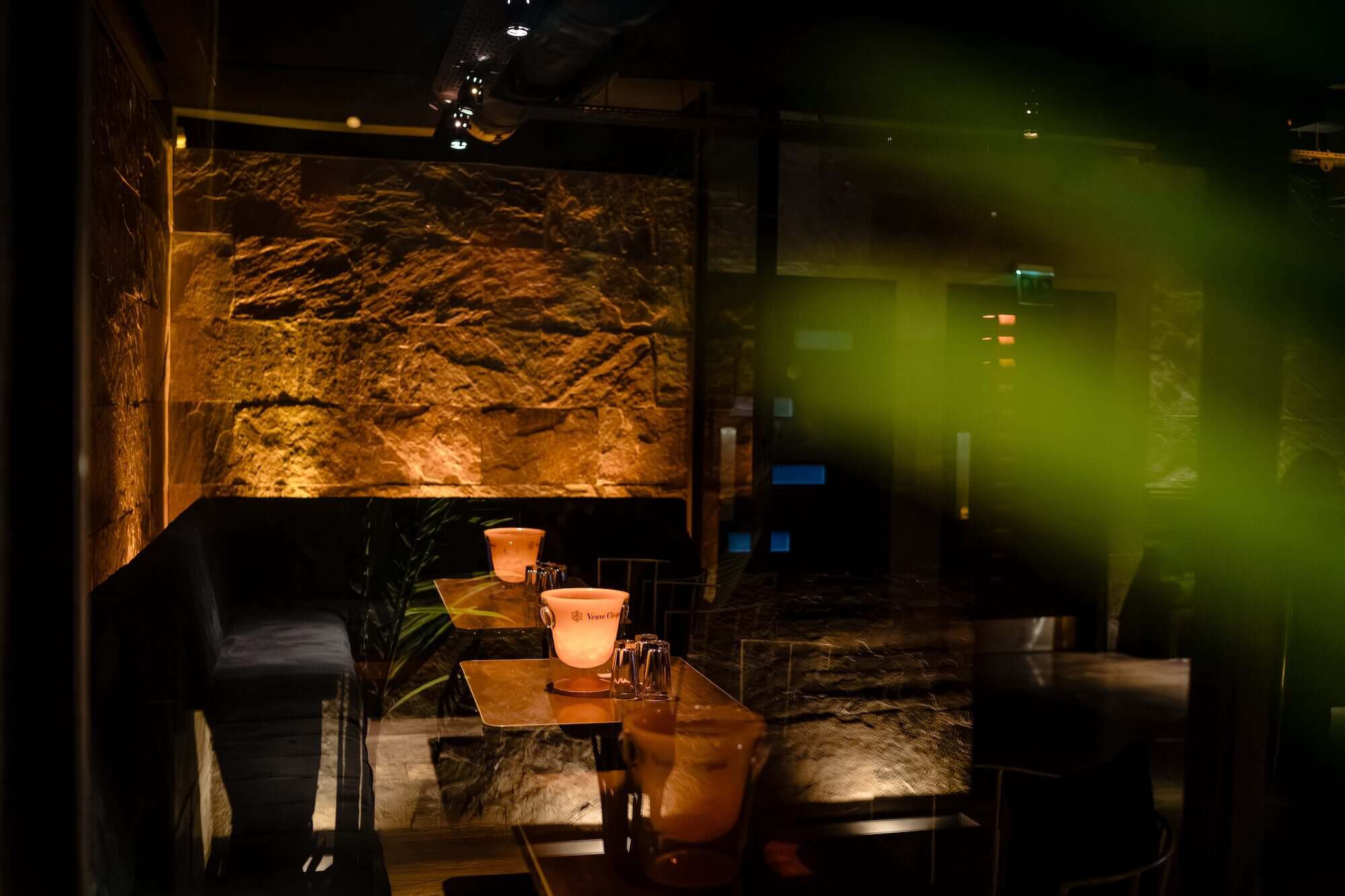 Candlelit basement wedding reception space with exposed stone at PÚRL Barbican, EC1 London