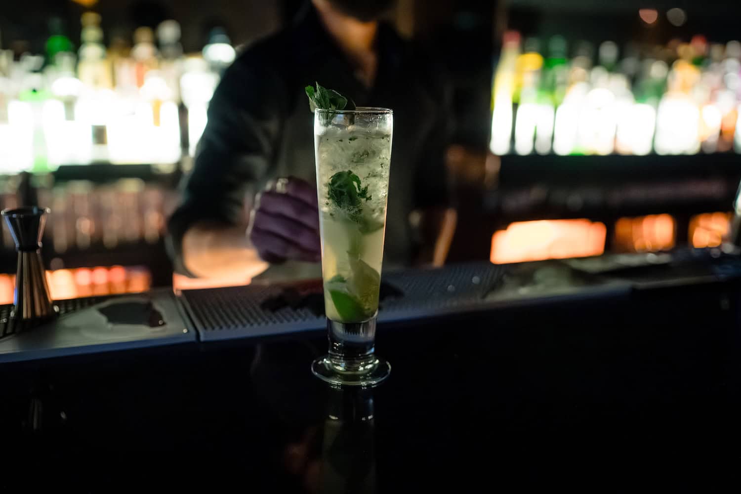 Bartender preparing a fresh cocktail at the bar during a private celebration at PÚRL Barbican